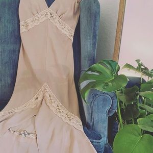 Creme colored lace sheer slip with a mermaid style flair and open back.